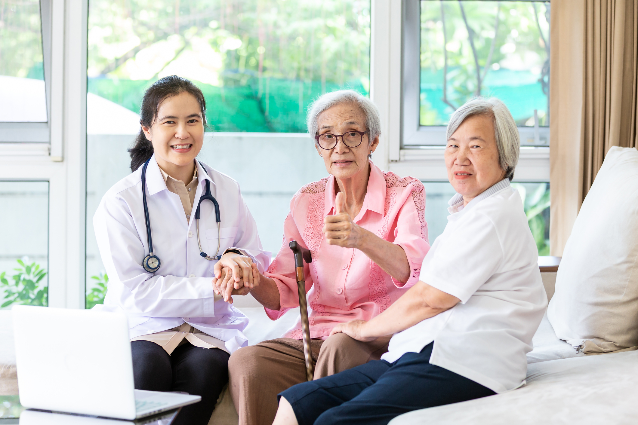 Two elderly women with a doctor