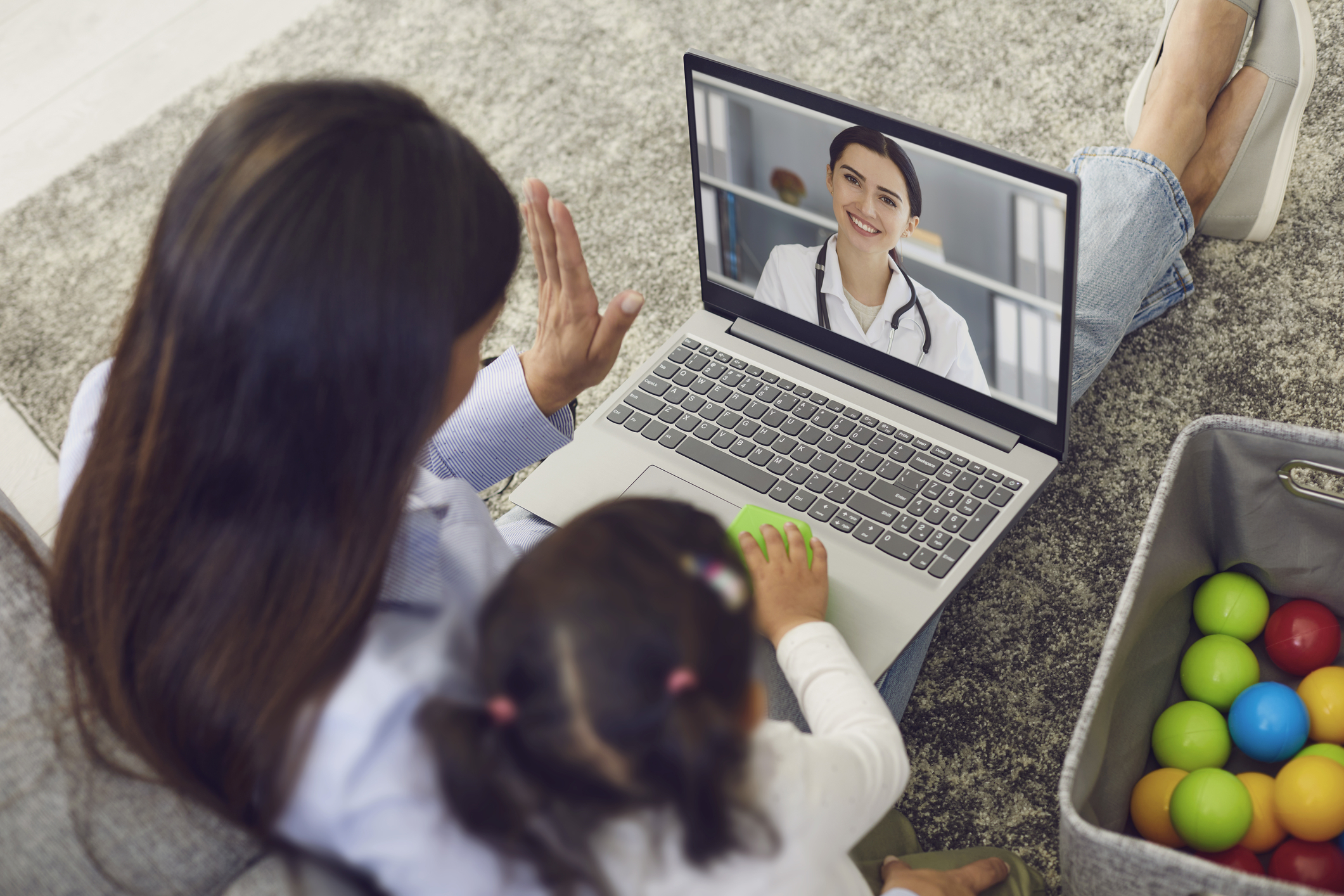 Mother and daughter having a telemedicine visit